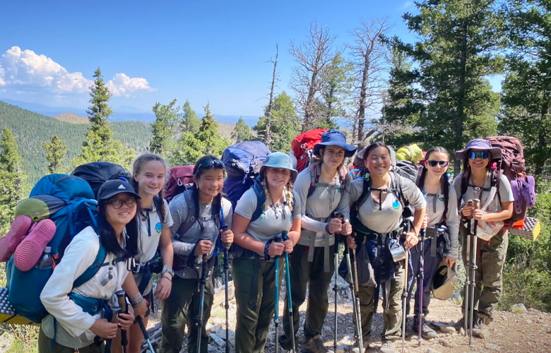 BSA Scout Troop 5056G stand on top of a mountain at Philmont 2024